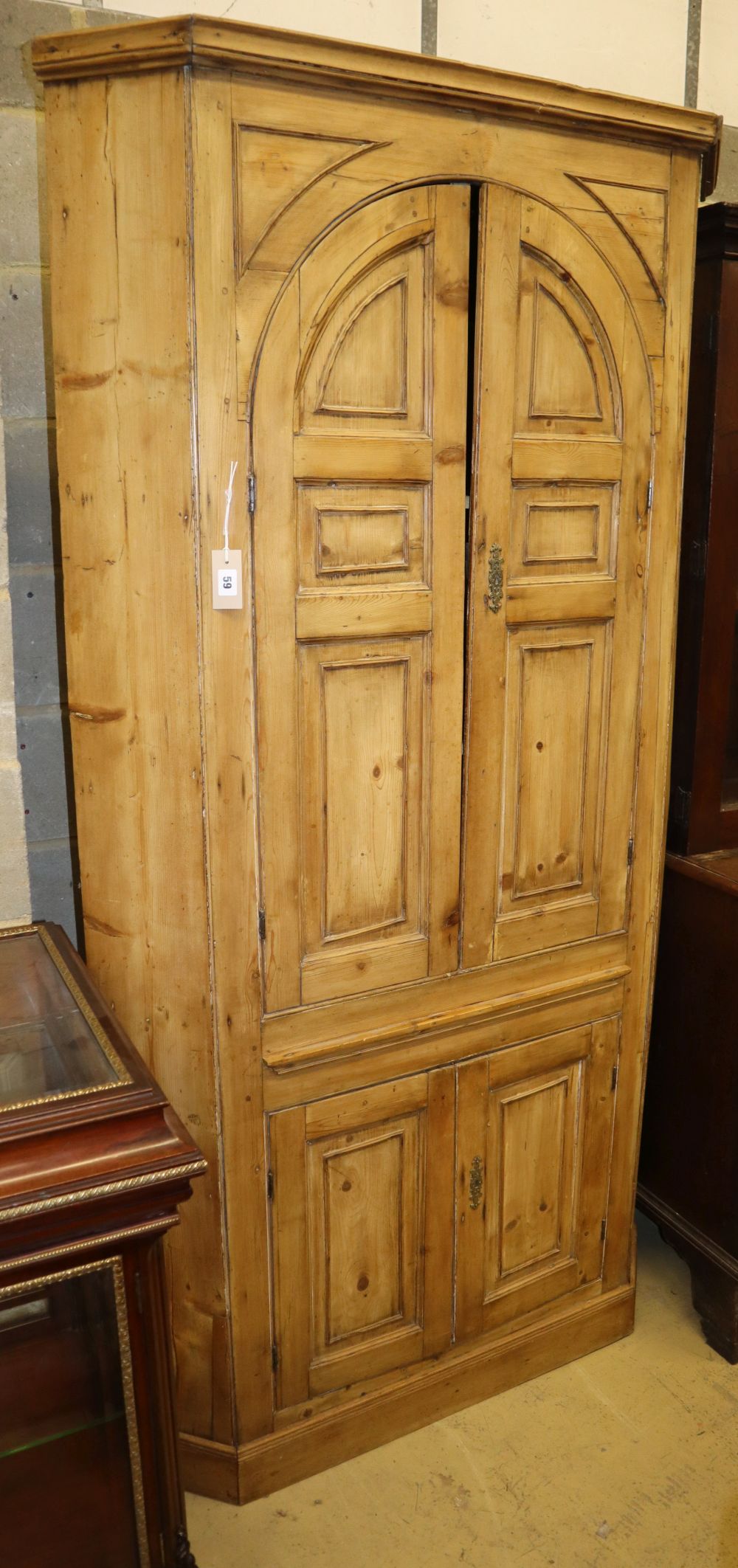 A George III pine barrel back standing corner cabinet, W.104cm, D.46cm, H.200cm